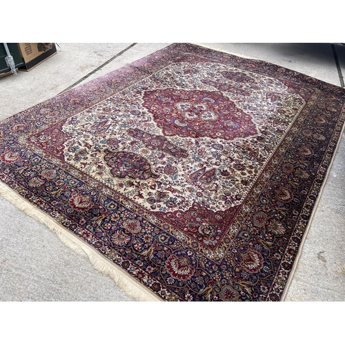 35 - A large red gold and blue pattern carpet 300x410