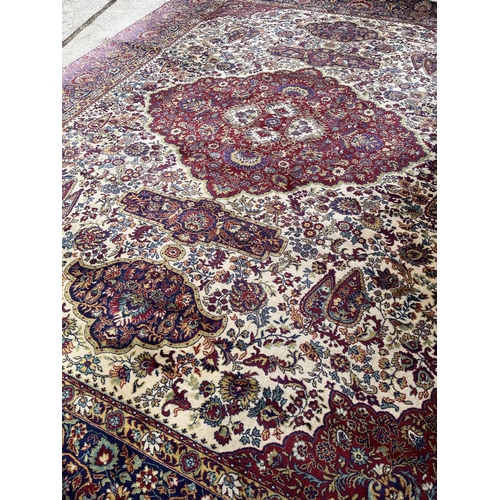 35 - A large red gold and blue pattern carpet 300x410