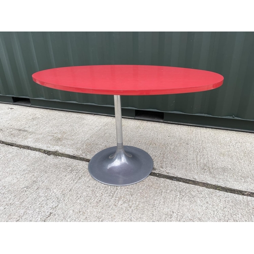 39 - A retro oval red formica kitchen table on circular aluminium pedestal base