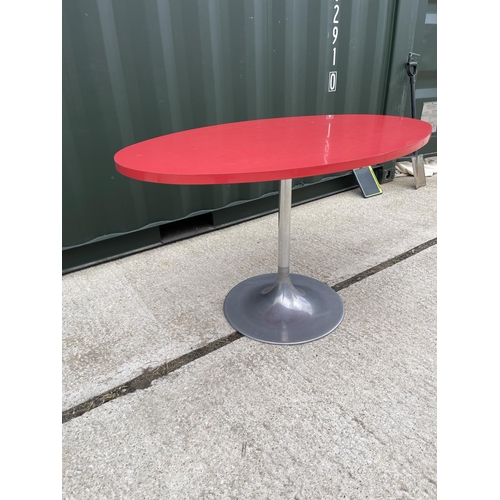 39 - A retro oval red formica kitchen table on circular aluminium pedestal base