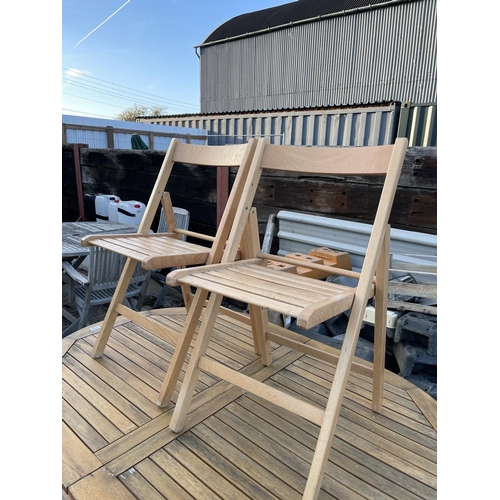 438 - An extending  wooden garden table and four folding chairs together with beige parasol