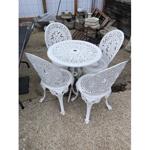 443 - A circular white painted aluminium garden table with four chairs