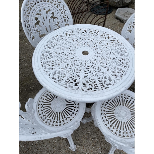 443 - A circular white painted aluminium garden table with four chairs