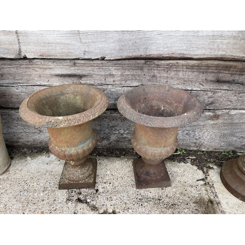 447 - A pair of small antique cast iron garden urns 40cm