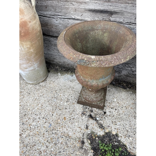 447 - A pair of small antique cast iron garden urns 40cm