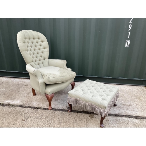 57 - A green upholstered button back fireside chair together with a stool