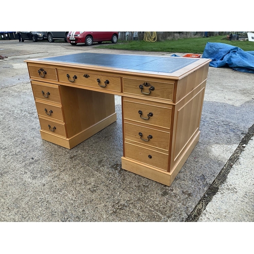 60 - A light oak twin pedestal desk