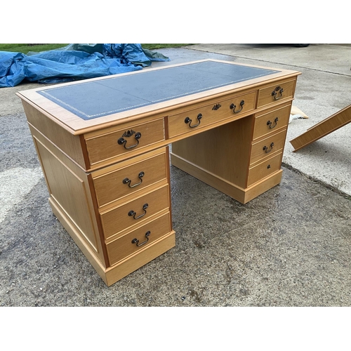 60 - A light oak twin pedestal desk