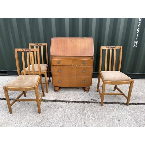 7 - A 1930's oak bureau together with three similar oak chairs