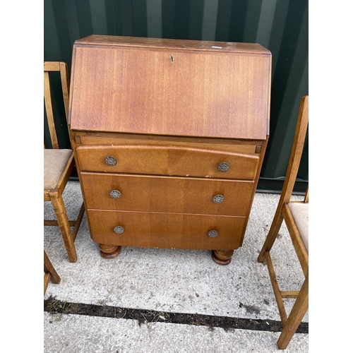 7 - A 1930's oak bureau together with three similar oak chairs