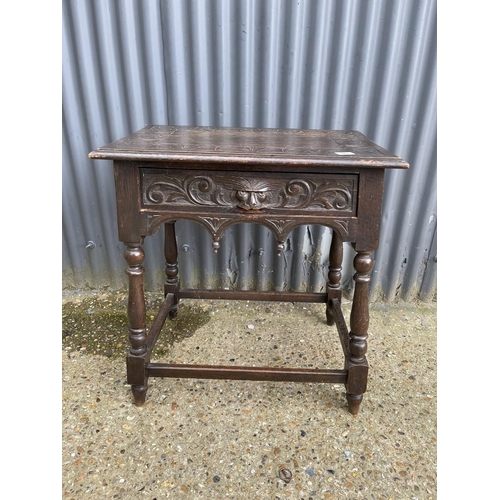 80 - A carved oak single drawer table