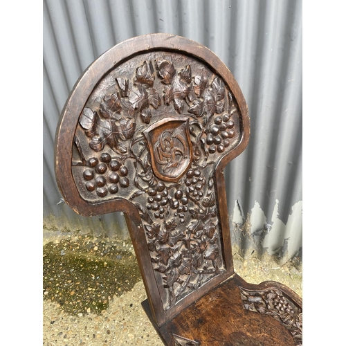 84 - A carved oak hall chair