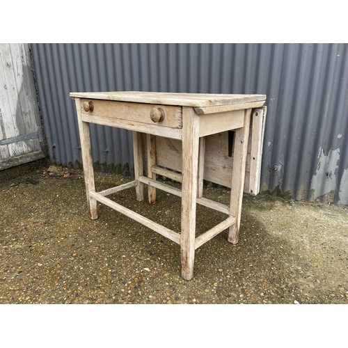 91 - A country pine farmhouse table with drop leaf