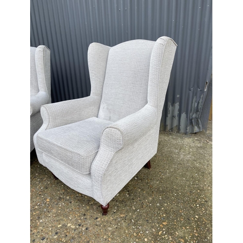 99 - A pair of modern grey upholstered wing back armchairs froM HSL