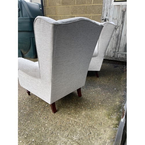 99 - A pair of modern grey upholstered wing back armchairs froM HSL