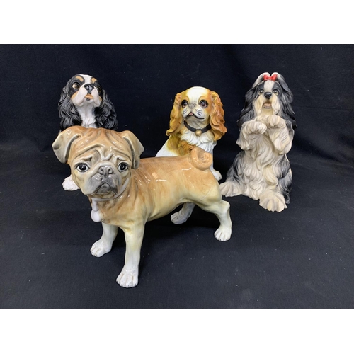 680 - 3 large resin dog figures and a large china Pug Figure, tallest 35cms