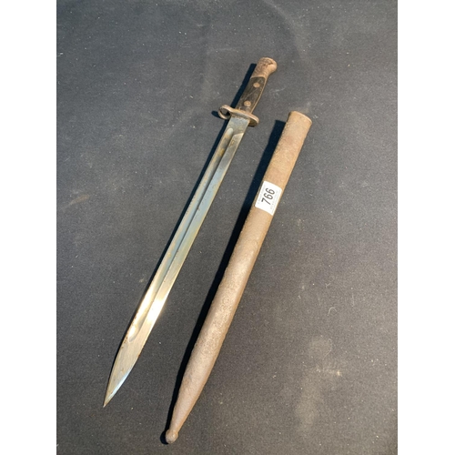 766 - Bayonet in scabbard, length 54 cms