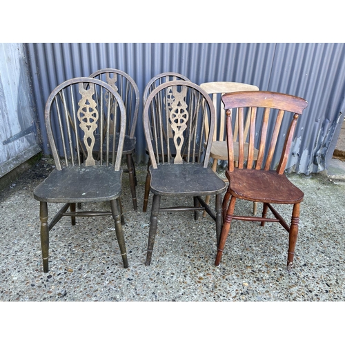 10 - A set of four wheel back chairs together with two country pine kitchen chairs