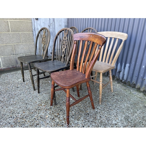 10 - A set of four wheel back chairs together with two country pine kitchen chairs