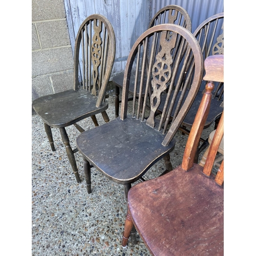 10 - A set of four wheel back chairs together with two country pine kitchen chairs