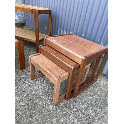 109 - A teak nest of three together with a teak tea trolley and a pine coffee table