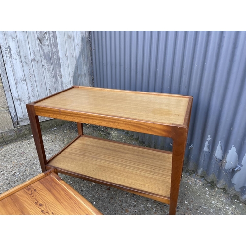 109 - A teak nest of three together with a teak tea trolley and a pine coffee table