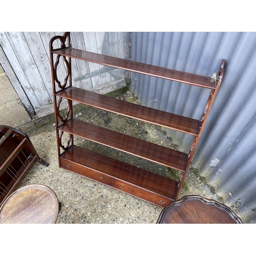 151 - A mahogany wall shelf, two wine tables, nest of three, side table and magazine rack