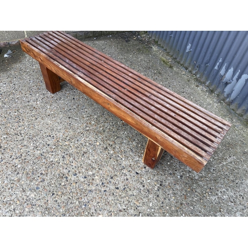 156 - An Indonesian fruitwood bench seat 180cm wide