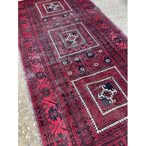 164 - A red oriemtal pattern rug 230x122