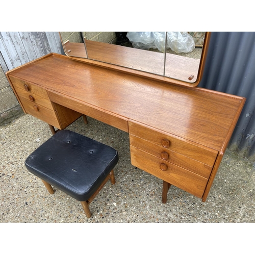 173 - A teak six drawer dressing table by MEREDEW with stool