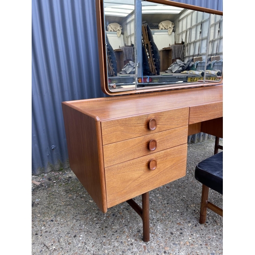 173 - A teak six drawer dressing table by MEREDEW with stool