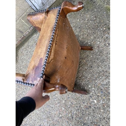 182 - A tan brown leather club style chair with brass studs