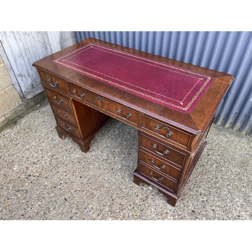 189 - A reproduction mahogany twin pedestal desk with a red leather top