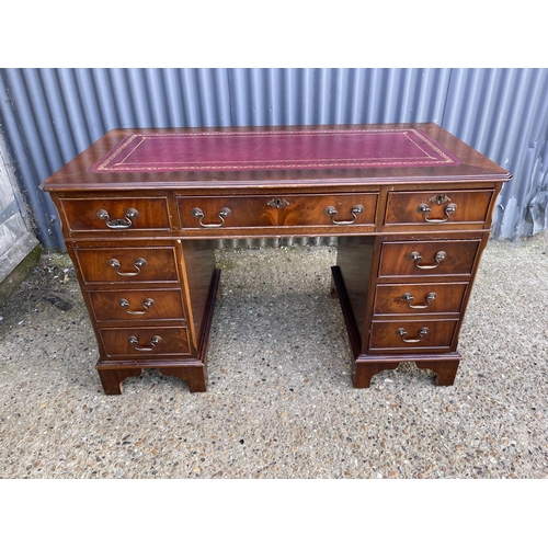 189 - A reproduction mahogany twin pedestal desk with a red leather top