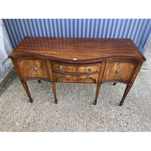 190 - A reproduction mahogany serpentine fronted sideboard