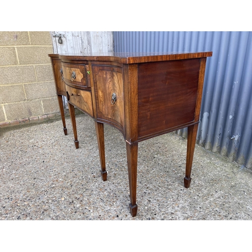 190 - A reproduction mahogany serpentine fronted sideboard