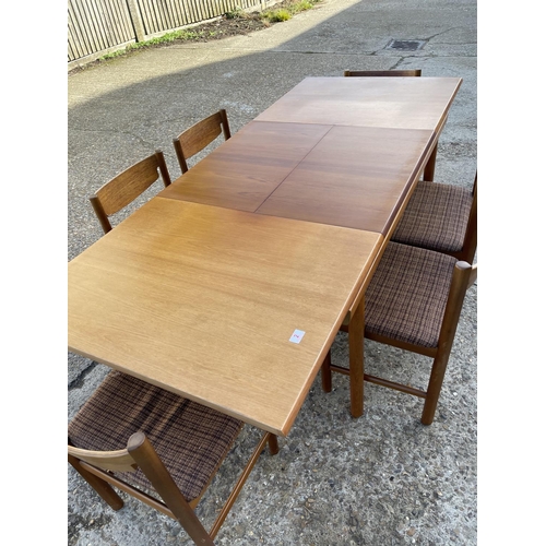 2 - An extending rectangular teak table and six teak chairs by White and Newton