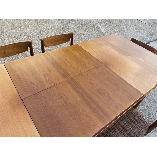 2 - An extending rectangular teak table and six teak chairs by White and Newton