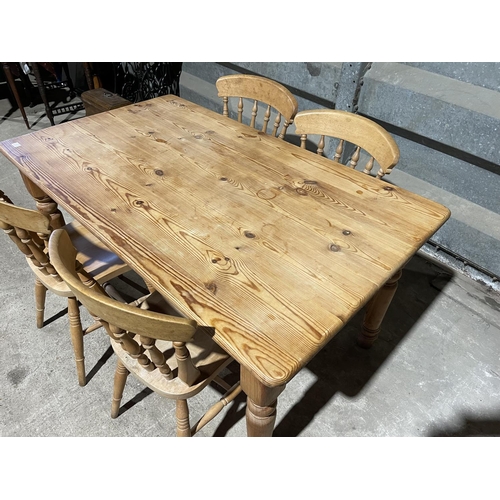 217 - A solid pine farmhouse table with four chairs