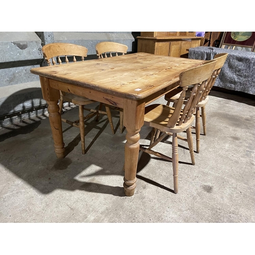 217 - A solid pine farmhouse table with four chairs