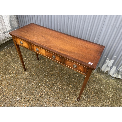 227 - A reproduction mahogany three drawer table by BEVAN AND FUNNEL