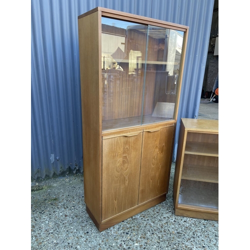 25 - A Macintosh style teak bookcase  cupboard together with a smaller teak glazed bookcase