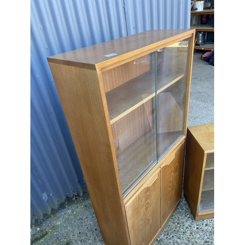 25 - A Macintosh style teak bookcase  cupboard together with a smaller teak glazed bookcase