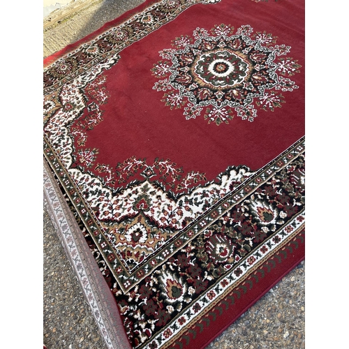 253 - A large red Axminster pattern carpet 300x240