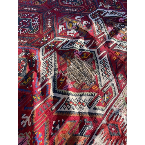 254 - A worn Aztec pattern rug 200x380