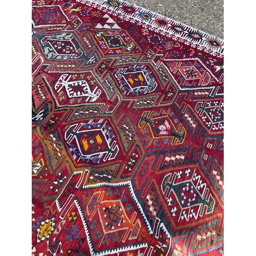 254 - A worn Aztec pattern rug 200x380