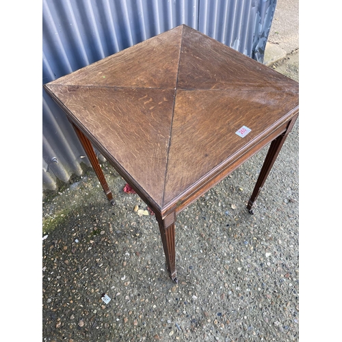 260 - An Edwardian oak envelope card table