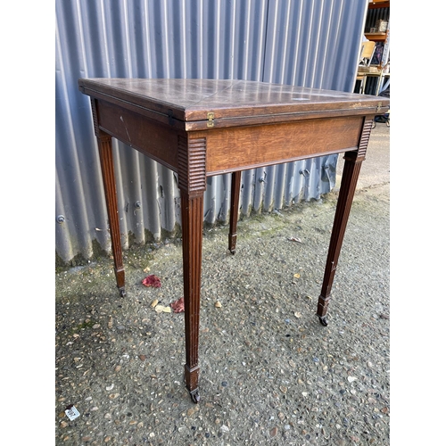 260 - An Edwardian oak envelope card table