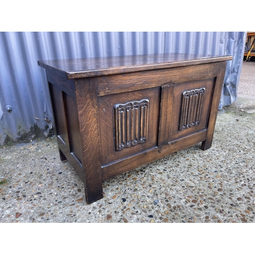 27 - A small oak blanket box with linenfold front