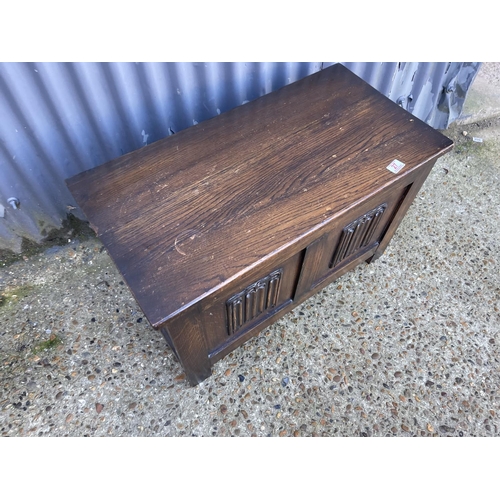 27 - A small oak blanket box with linenfold front